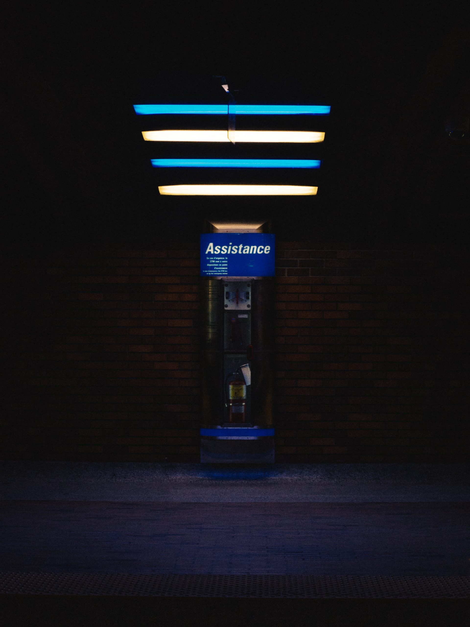 emergency response phone booth box with blue and white neon above it